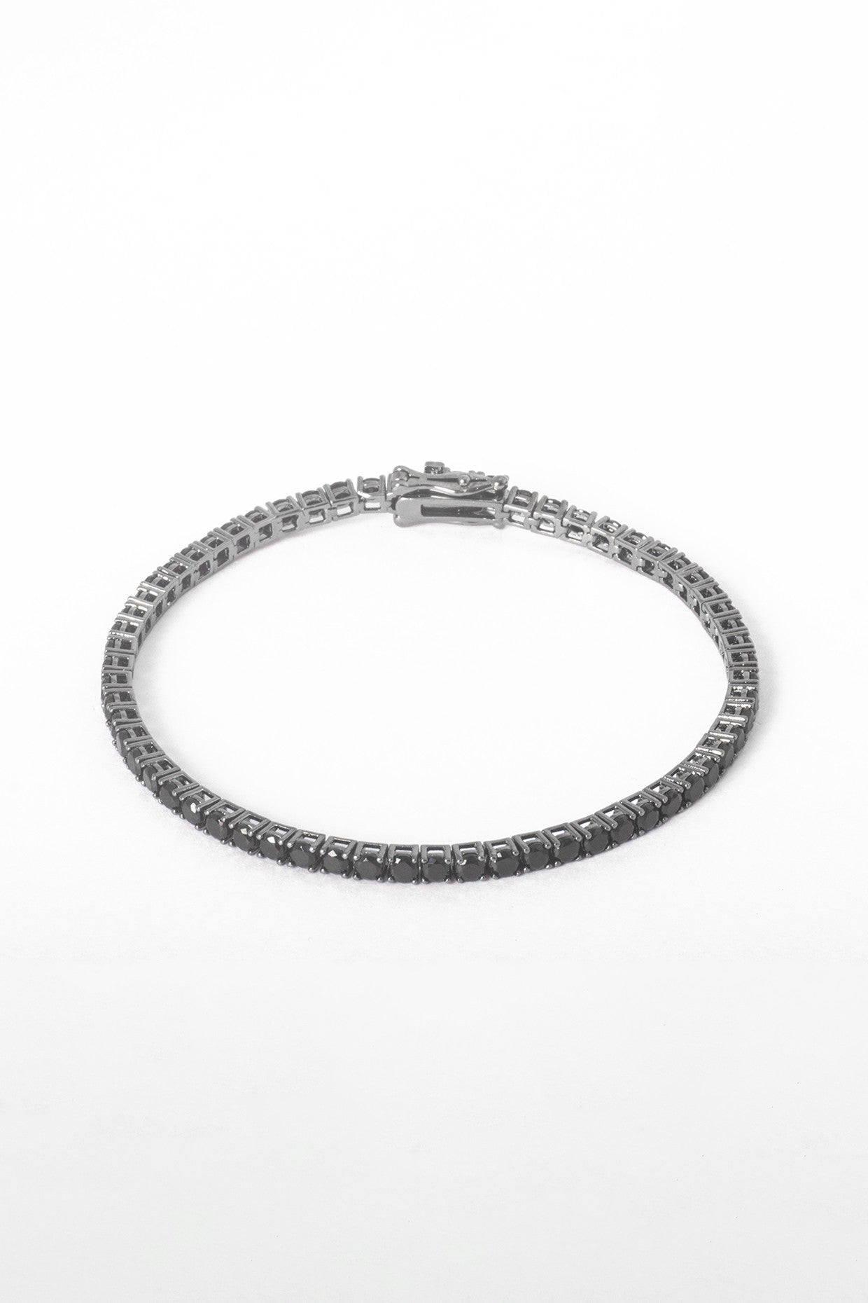 Silver bracelet with clear stones on a white background